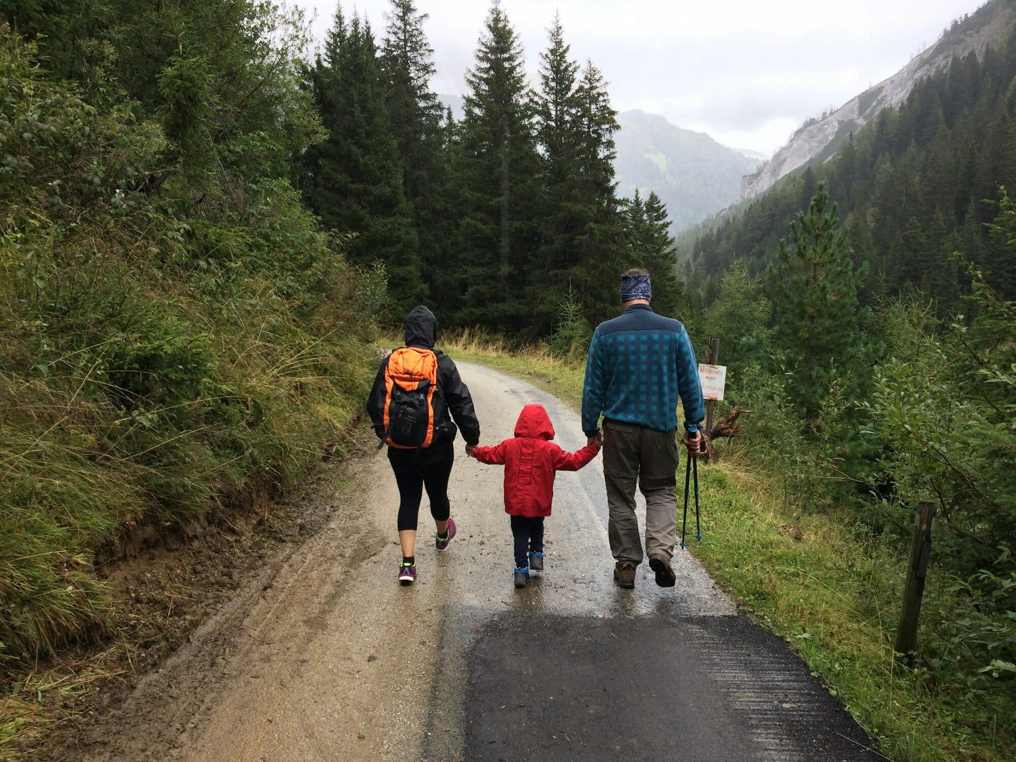 Family walking along a mountain road